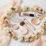 Icon of makeup tools and delicate floral garlands representing engagement makeup service at LaturMakeup, soft peach and pink tones.
